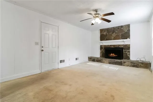a view of an empty room with a fireplace