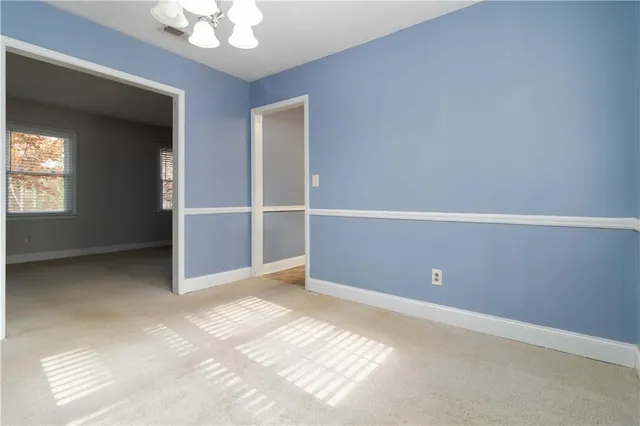 an empty room with closet and windows