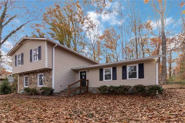 a front view of a house with a garden