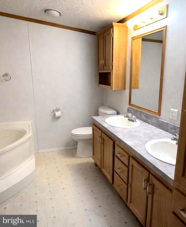 148 1st Street Lothian, MD 20711 - Photo 21 of 29 a bathroom with a granite countertop sink a toilet and bathtub