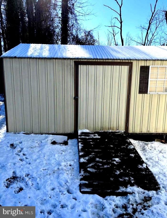 148 1st Street Lothian, MD 20711 - Photo 25 of 29 a view of a wooden house with a bench
