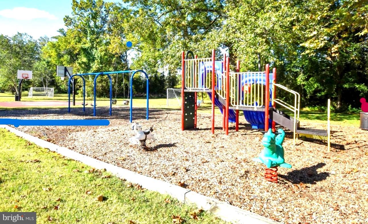 148 1st Street Lothian, MD 20711 - Photo 27 of 29 a view of a park with large trees and slides