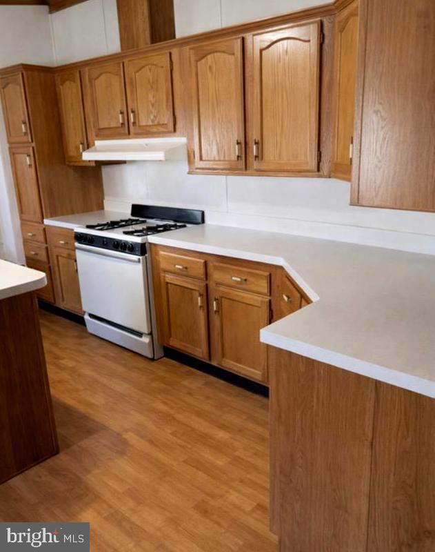 148 1st Street Lothian, MD 20711 - Photo 7 of 29 a kitchen with granite countertop a sink a stove and cabinets