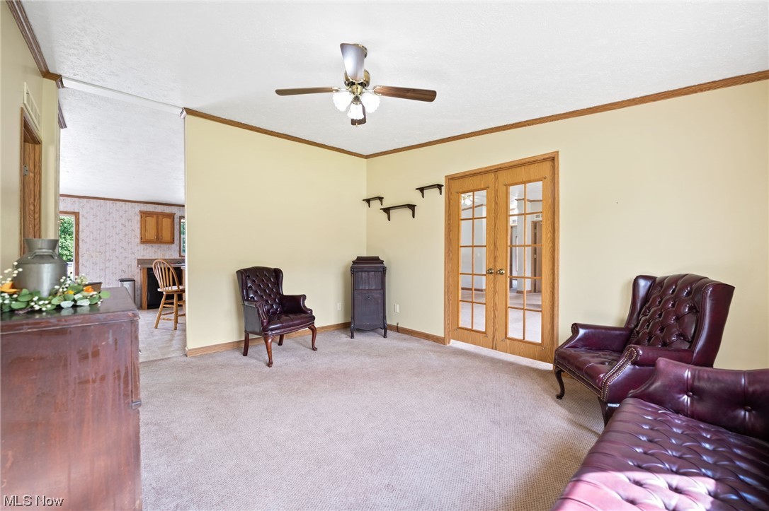 6268 Peck Road Ravenna, OH 44266 - Photo 11 of 25 Sitting room with ceiling fan, light carpet, crown molding, and french doors