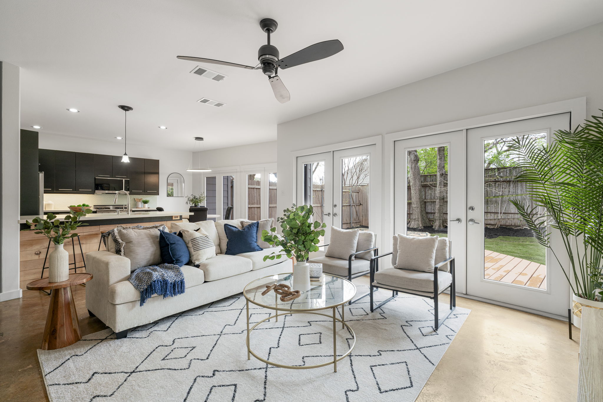 Large windows and doors bring in beautiful natural light while framing peaceful views of the private backyard.