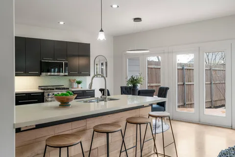 a kitchen with stainless steel appliances granite countertop a sink counter space and cabinets
