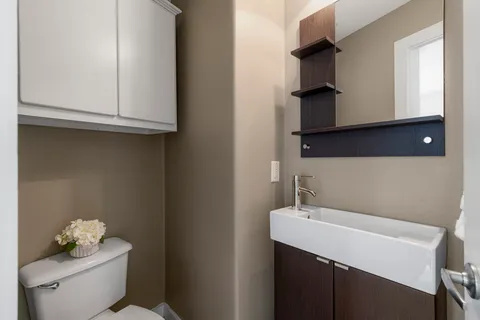 a bathroom with a sink a toilet and vanity