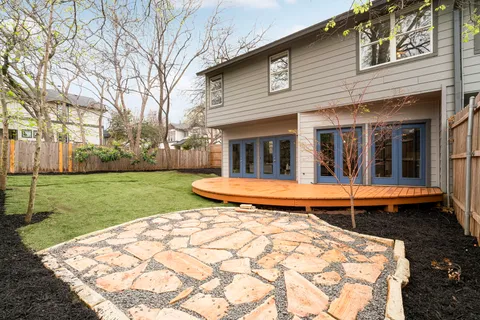 a view of a house with a yard and sitting area