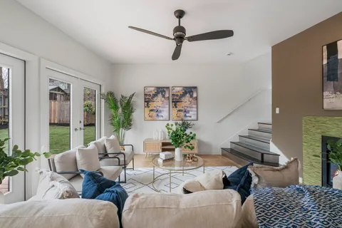 a kitchen with stainless steel appliances a stove a sink a microwave a refrigerator and chairs