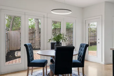 a bedroom with a bed chandelier and a window