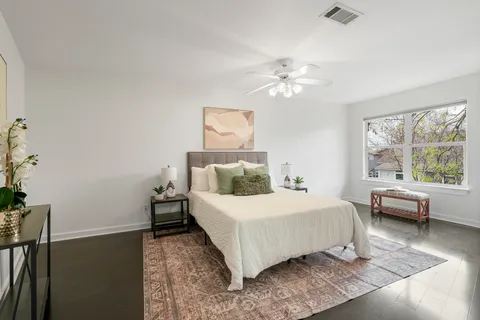 a bathroom with a granite countertop toilet sink and mirror