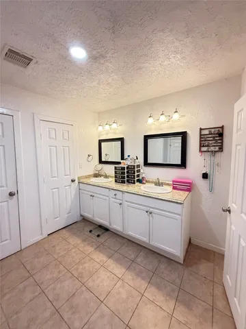 a kitchen with sink cabinets and window