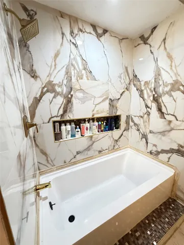a bath tub sitting next to a white sink
