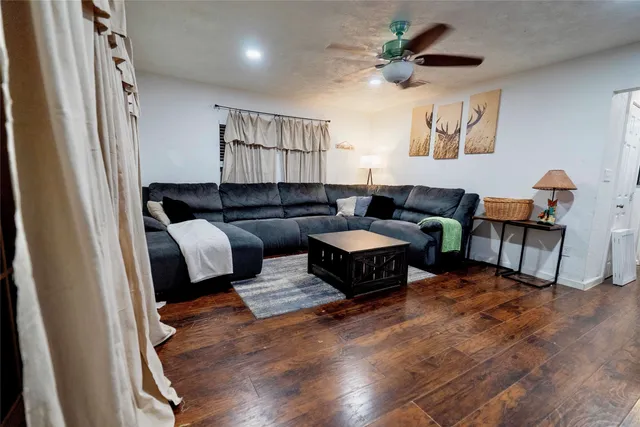 a living room with furniture a rug and a window