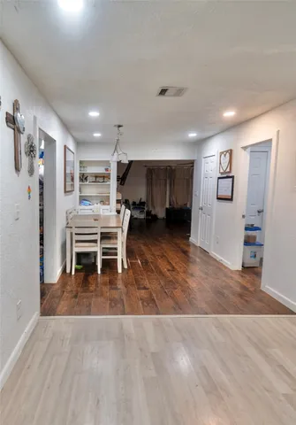 a view of a livingroom with furniture and an empty room