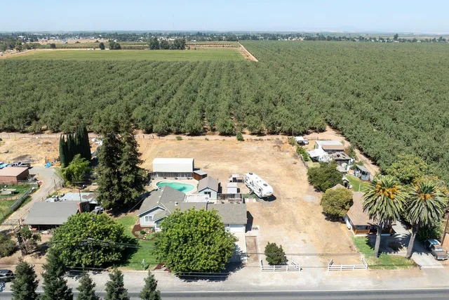 an aerial view of ocean with residential house with outdoor space