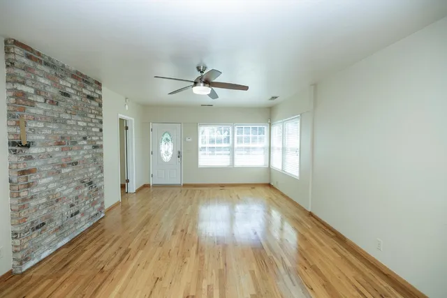 a large kitchen with stainless steel appliances kitchen island granite countertop a sink and cabinets