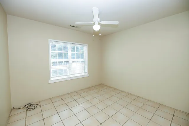 a view of a patio with table and chairs with wooden floor and fence