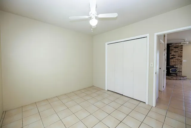 a view of a backyard with chairs and a barbeque