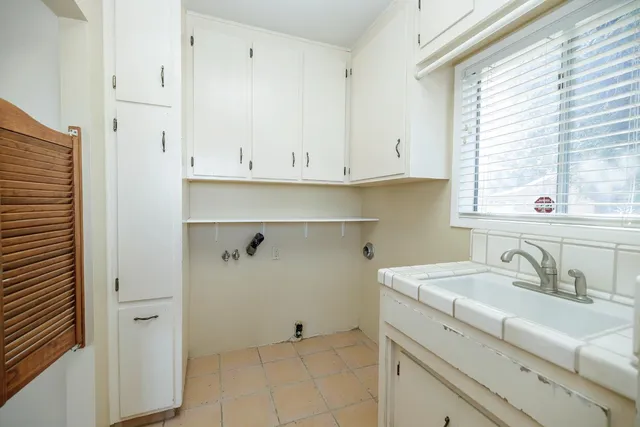 a view of a house with a yard and potted plants