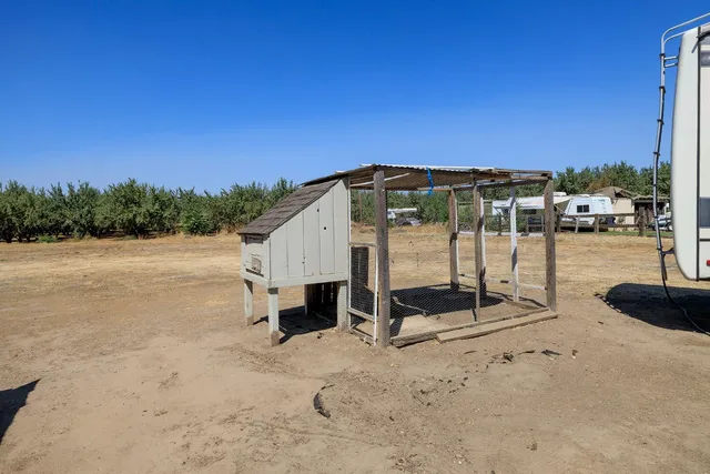 an aerial view of a house with swimming pool and porch