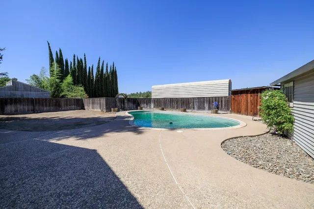 an aerial view of a house with garden space and street view