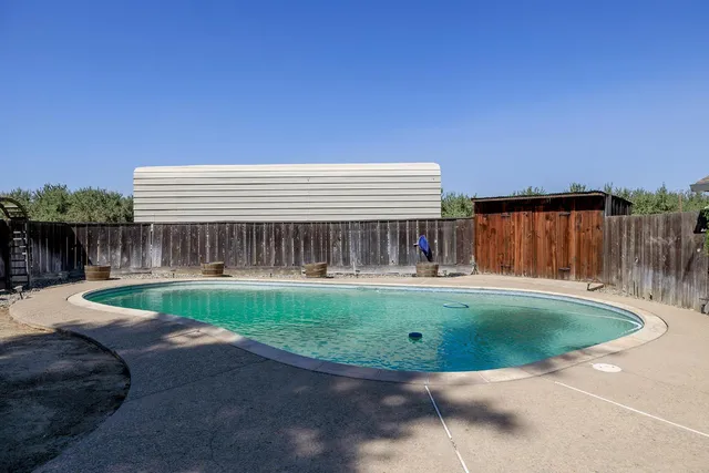 an aerial view of a house with garden space and street view