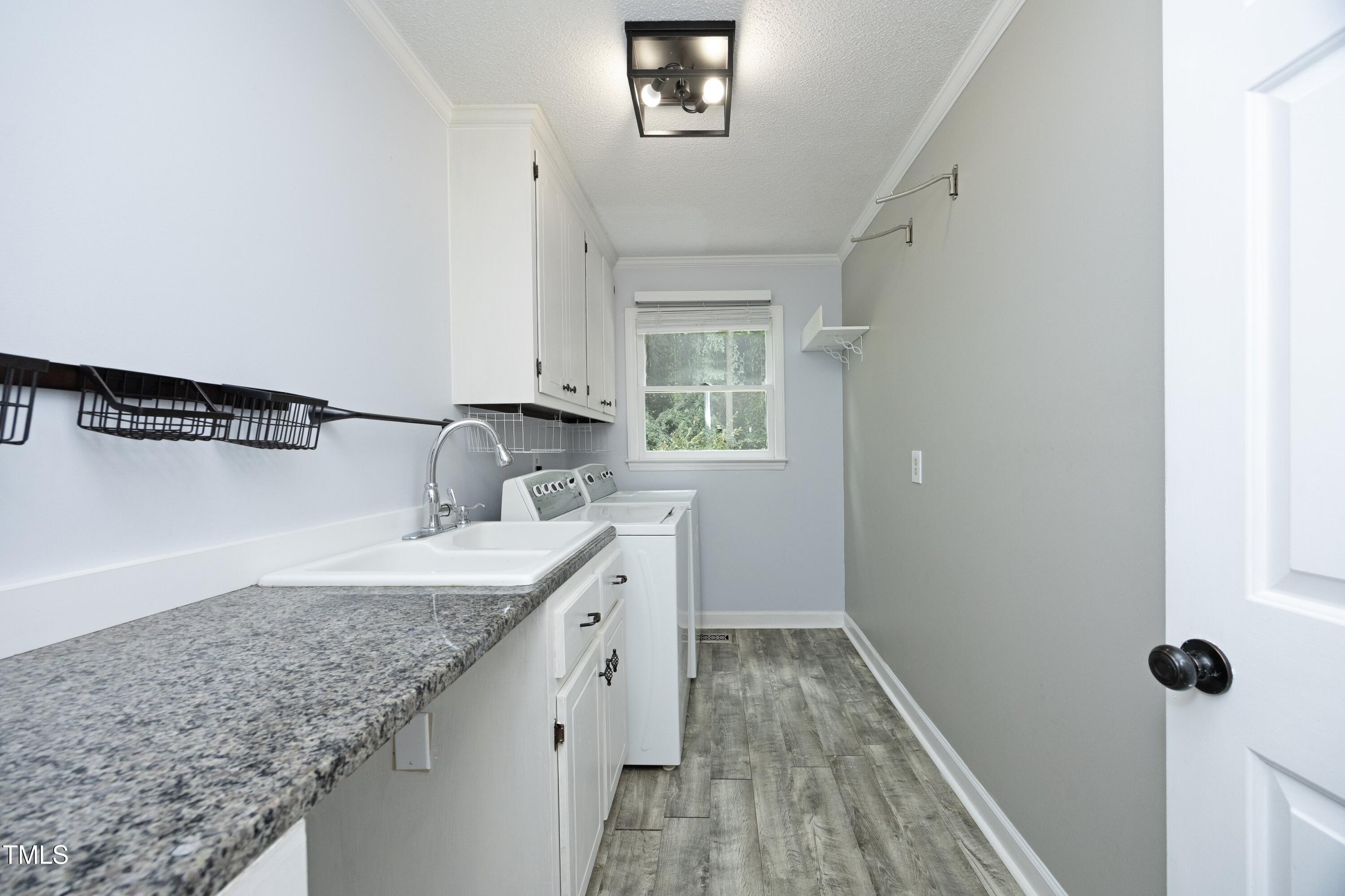 409 Glaive Drive Durham, NC 27703 - Photo 17 of 35 a bathroom with a granite countertop sink and mirror with bathtub