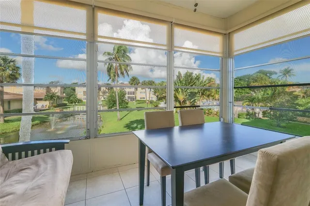 a view of a dining room with furniture and window
