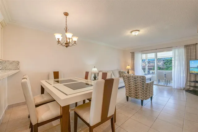 a kitchen with kitchen island granite countertop wooden floor and white cabinets