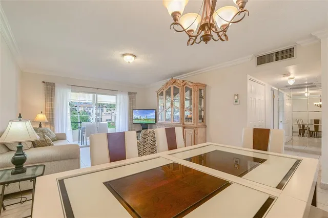 a kitchen with a stove a sink a dining table and chairs