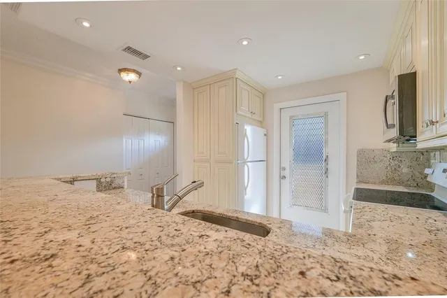 a kitchen with white cabinets and a sink