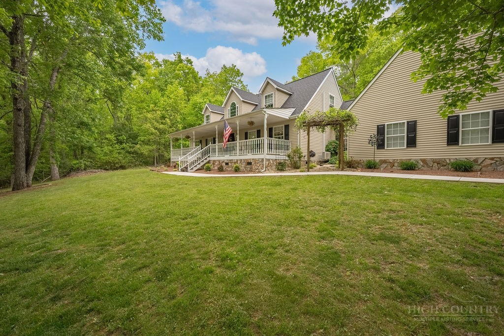 970 Vox Road Sparta, NC 28675 - Photo 2 of 50 a view of a house with a yard and sitting area