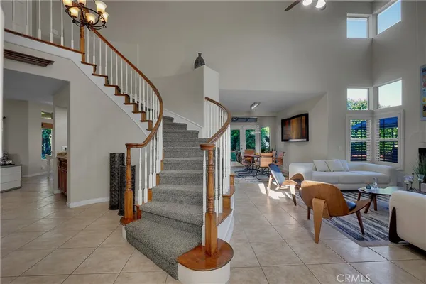 a living room with lots of furniture and a large window