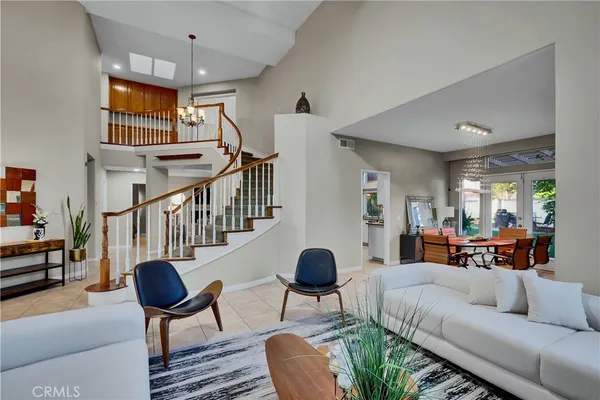 a living room with furniture and a chandelier
