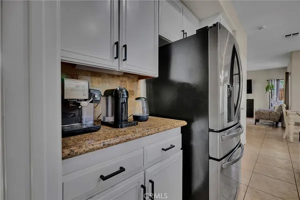 a kitchen with granite countertop stainless steel appliances and refrigerator