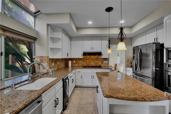 a kitchen with a stove sink and refrigerator
