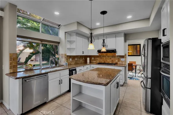 a kitchen with stainless steel appliances and cabinets