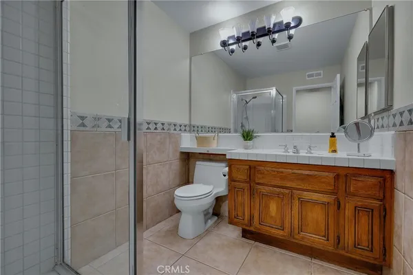 a bathroom with a granite countertop shower and a sink