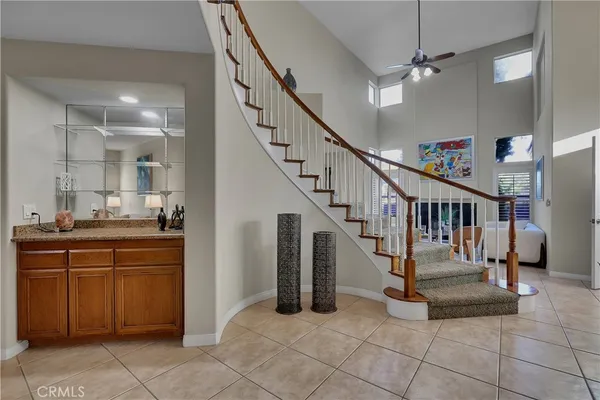 a bedroom with a bed and large windows