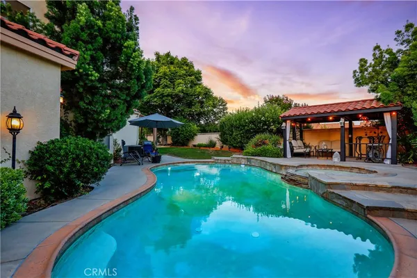 a view of a house with swimming pool yard and patio