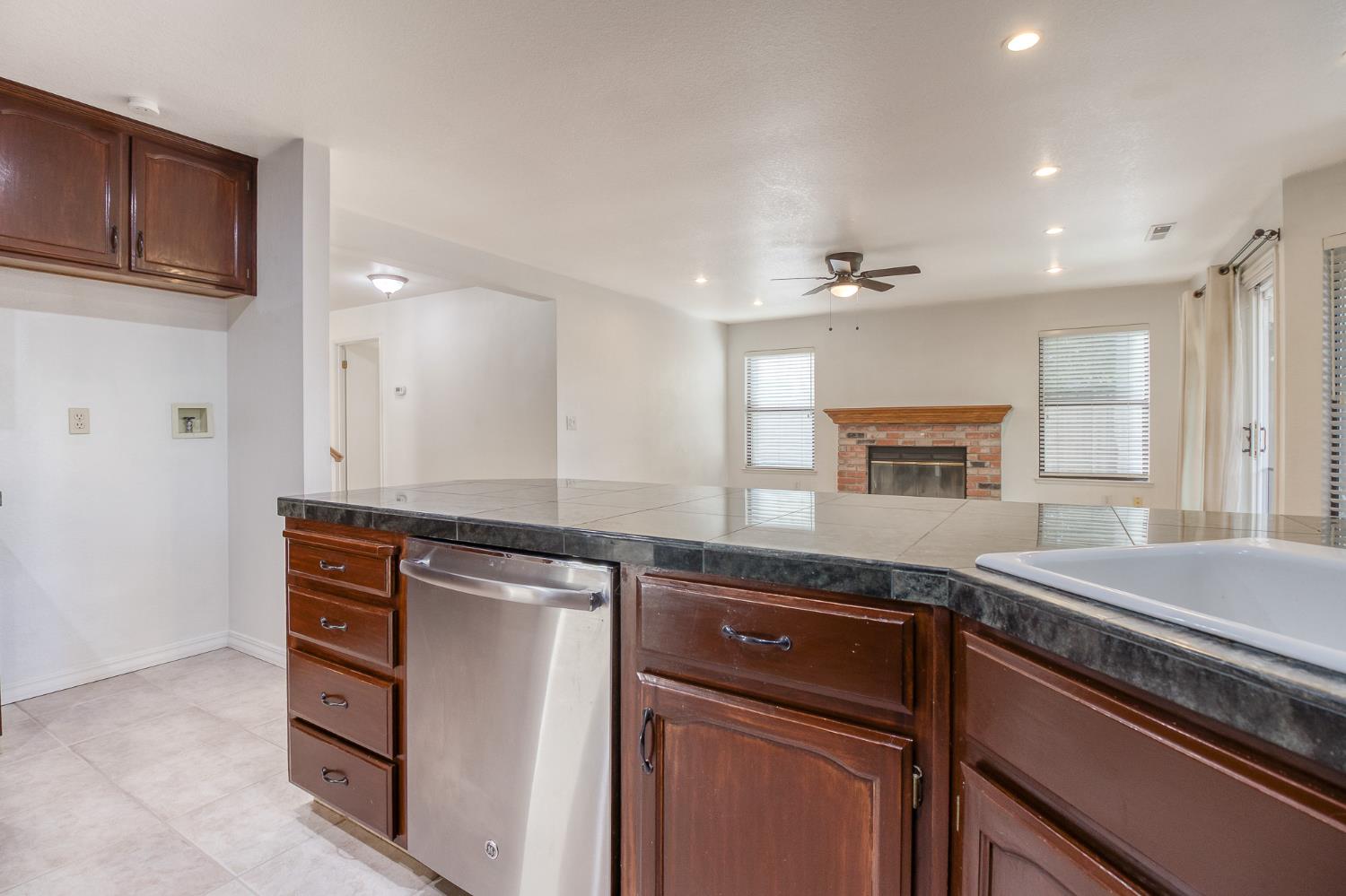 4209 Godfrey Drive Salida, CA 95368 - Photo 12 of 34 a kitchen with stainless steel appliances granite countertop a sink and a stove