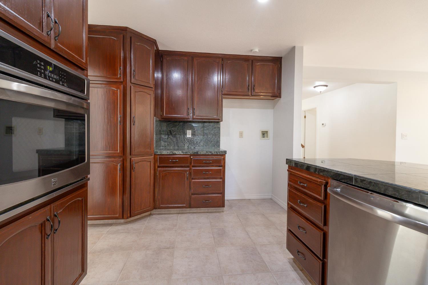 4209 Godfrey Drive Salida, CA 95368 - Photo 13 of 34 a kitchen with stainless steel appliances granite countertop a refrigerator and a sink