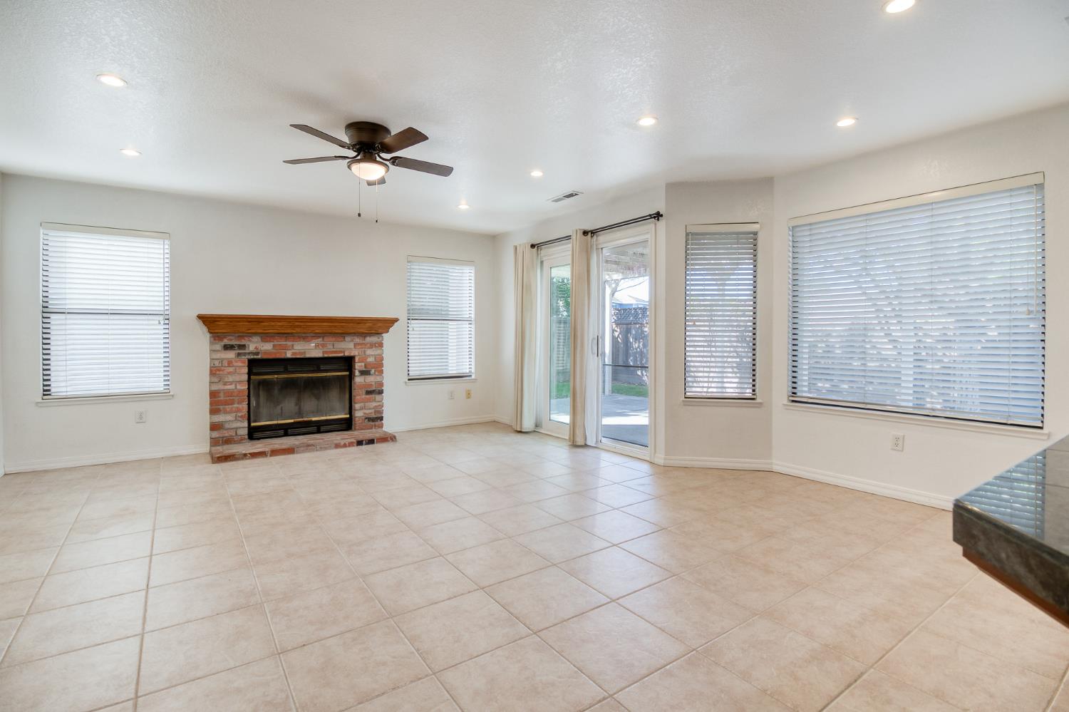 4209 Godfrey Drive Salida, CA 95368 - Photo 15 of 34 a view of an empty room with a fireplace and a window