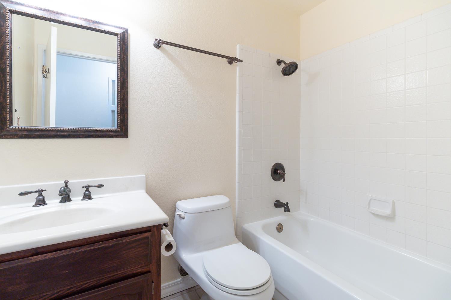 4209 Godfrey Drive Salida, CA 95368 - Photo 20 of 34 a bathroom with a bathtub shower sink vanity and toilet