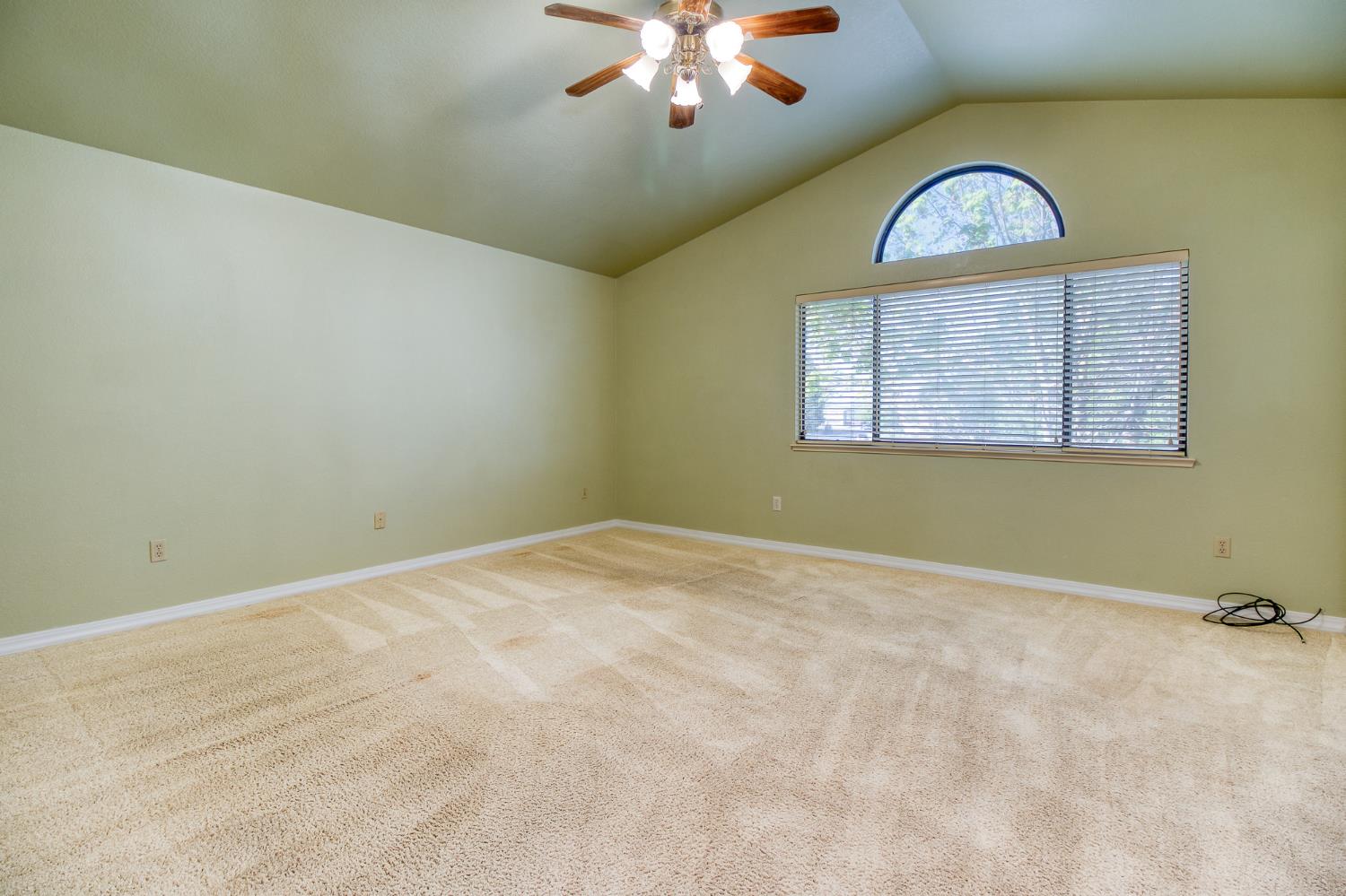 4209 Godfrey Drive Salida, CA 95368 - Photo 22 of 34 an empty room with a chandelier fan and windows