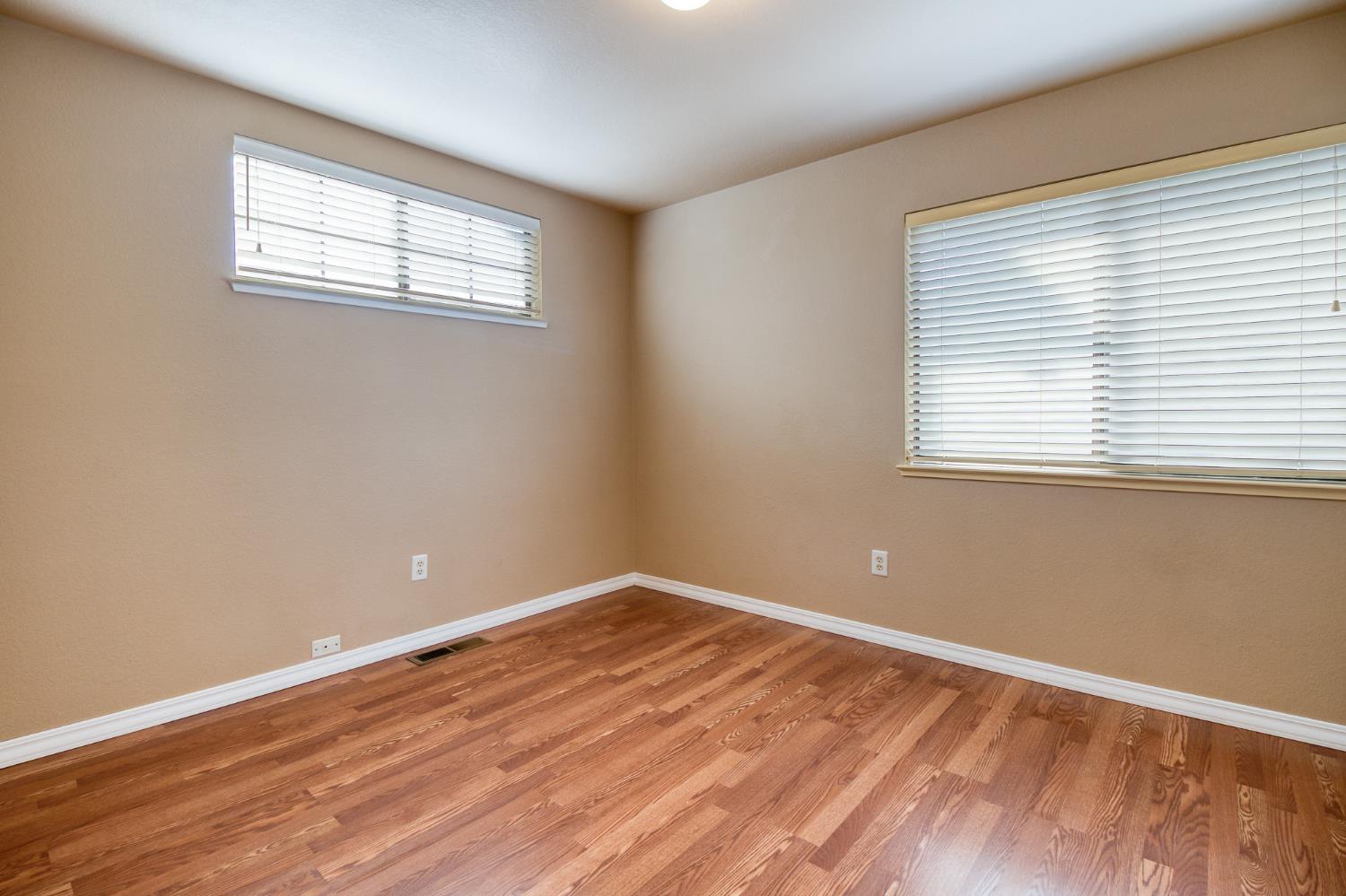 4209 Godfrey Drive Salida, CA 95368 - Photo 29 of 34 a view of an empty room with wooden floor and a window