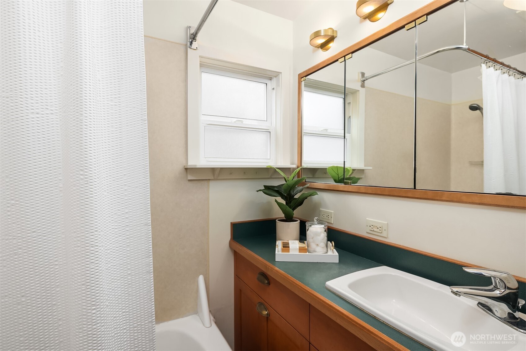548 Northeast 102nd Street Seattle, WA 98125 - Photo 13 of 22 a bathroom with a sink and a mirror