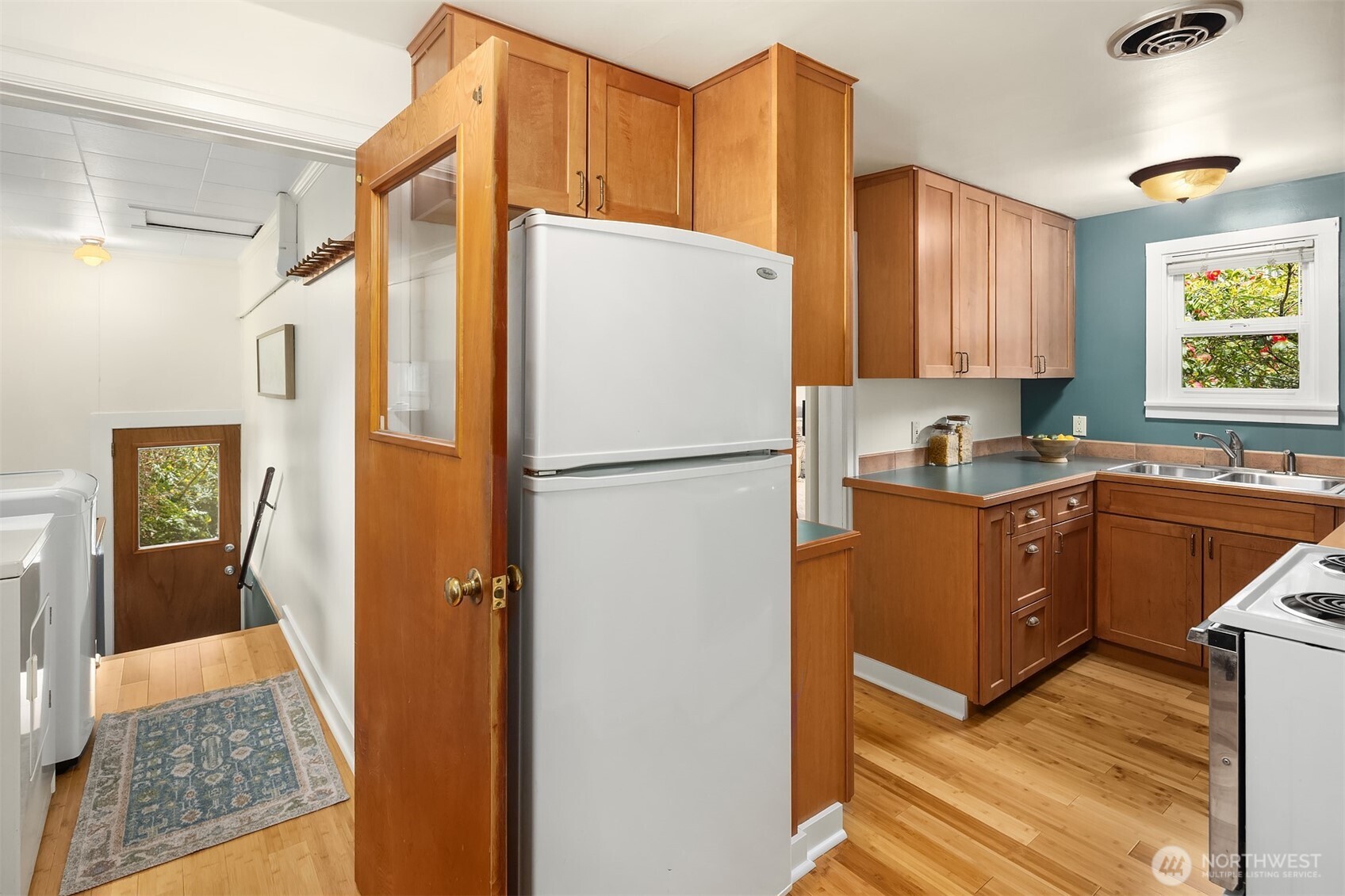 548 Northeast 102nd Street Seattle, WA 98125 - Photo 7 of 22 a kitchen with stainless steel appliances granite countertop a refrigerator and a sink