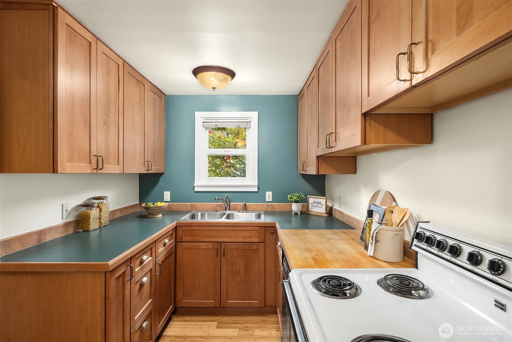 548 Northeast 102nd Street Seattle, WA 98125 - Photo 8 of 22 a kitchen with a sink a stove and cabinets